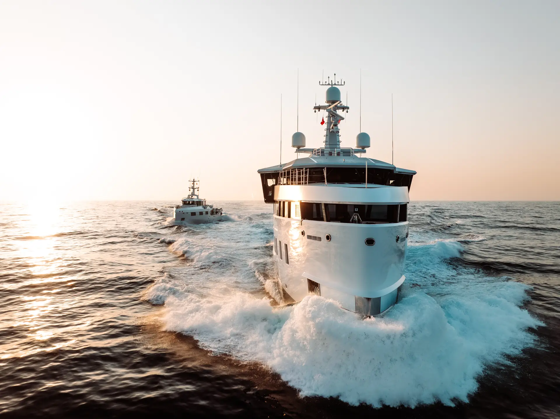 AFTER YOU three-quarter bow underway at sunset with support vessel