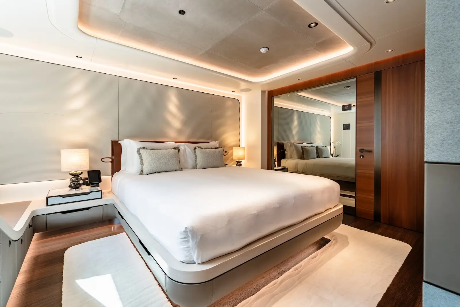 Guest cabin with pale timber headboard and soft indirect lighting